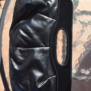 Black clutch bag snap closure top. Has zipper pocket inside.